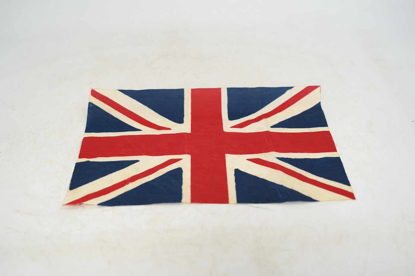 A vintage Union flag, approximately 240 x 120cm, a smaller “Sale” flag and other assorted flags and bunting. Condition - fair